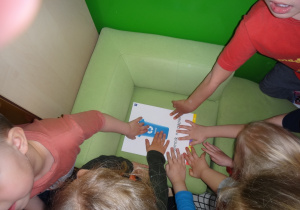 Dzieci wskazują pojemnik na papier